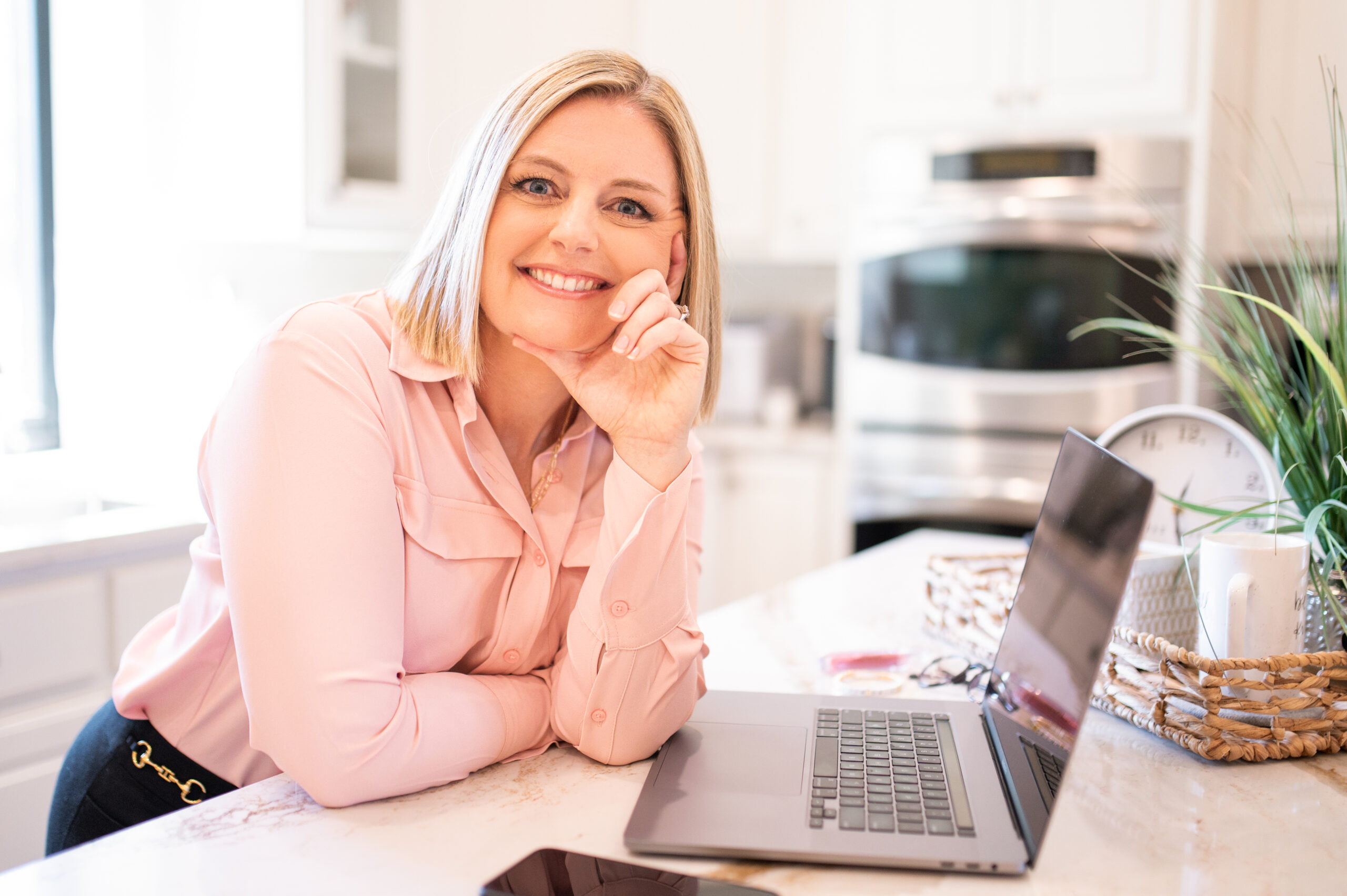 Kelli Michelle Creative Co. helping wedding professionals with blog SEO strategies at laptop
