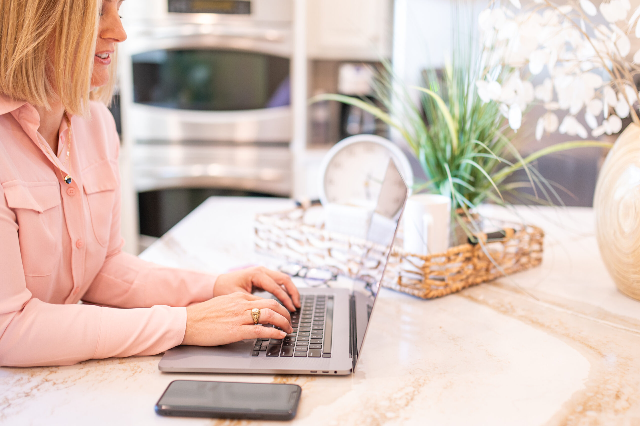 Owner of Kelli Michelle Creative Co busy on her laptop helping wedding planners with pinterest marketing